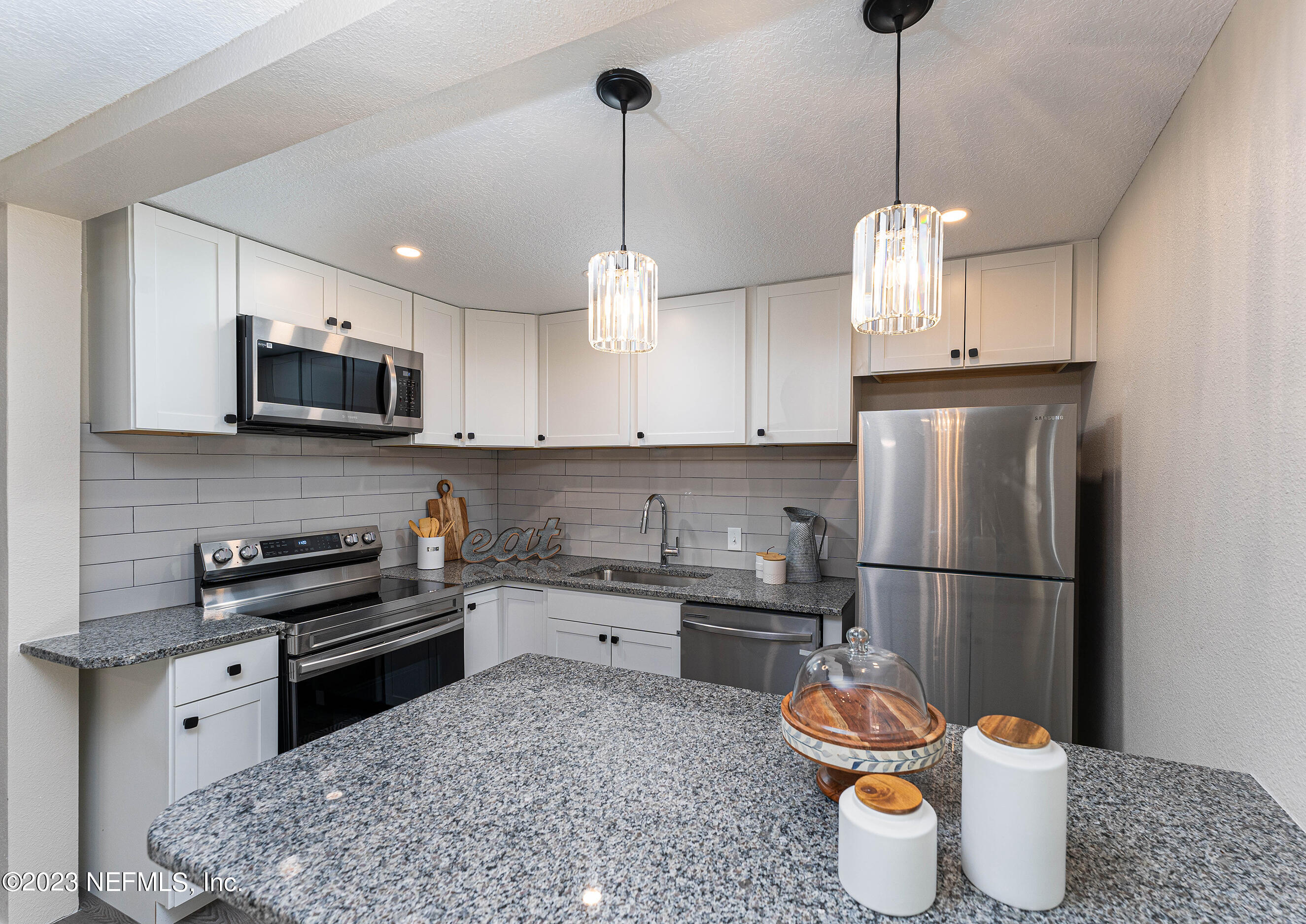 939 Westgate Drive Jacksonville, FL 32221 - Photo 9 of 31 a kitchen with stainless steel appliances granite countertop a sink a stove a refrigerator and microwave