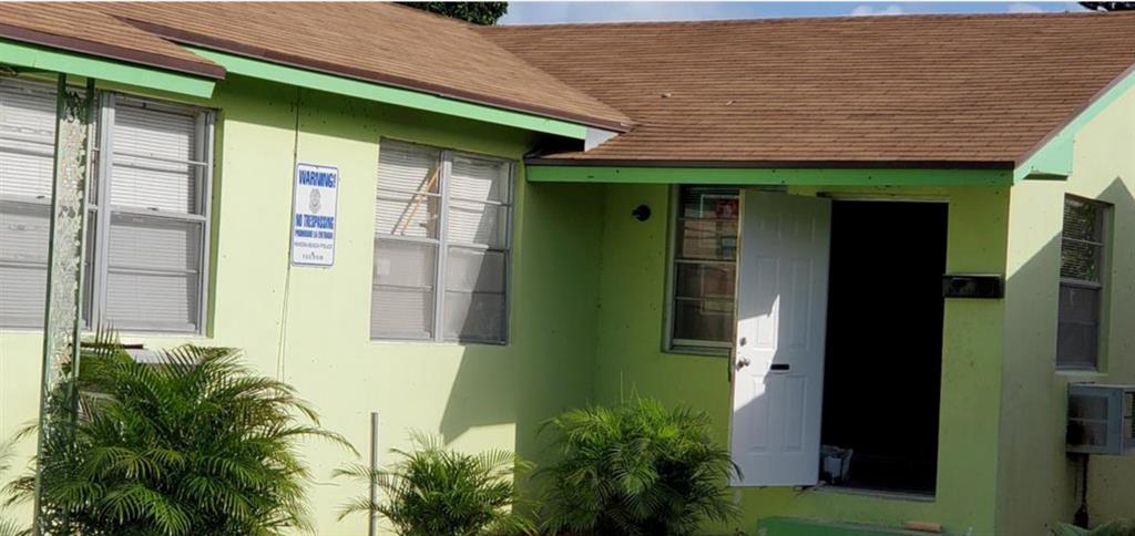 143 West 17th Street Riviera Beach, FL 33404 - Photo 13 of 13 a front view of a house with a garden