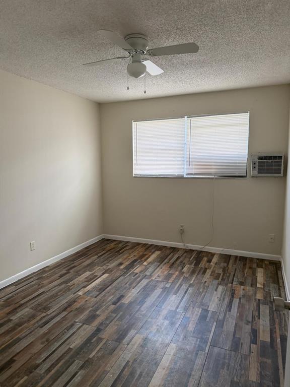 143 West 17th Street Riviera Beach, FL 33404 - Photo 4 of 13 a view of an empty room with wooden floor and a window