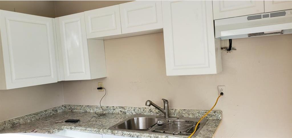 143 West 17th Street Riviera Beach, FL 33404 - Photo 8 of 13 a kitchen with a sink and cabinets