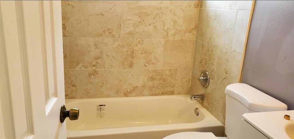 143 West 17th Street Riviera Beach, FL 33404 - Photo 9 of 13 a bathroom with a tub and a shower