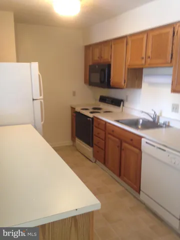 a kitchen with a sink a stove and refrigerator