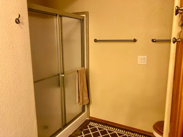 a bathroom with a glass door shower