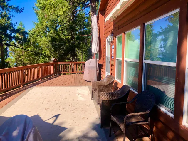 a balcony with wooden floor and outdoor seating