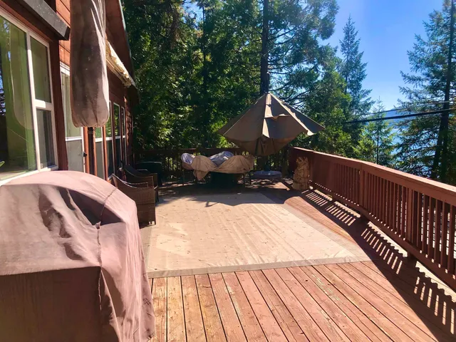 a view of balcony with wooden floor and fence
