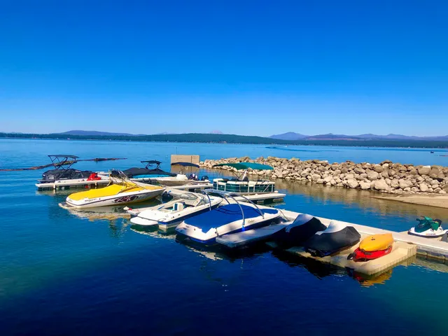a view of a lake with lawn chairs