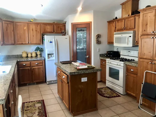 a kitchen with a stove a refrigerator and a sink