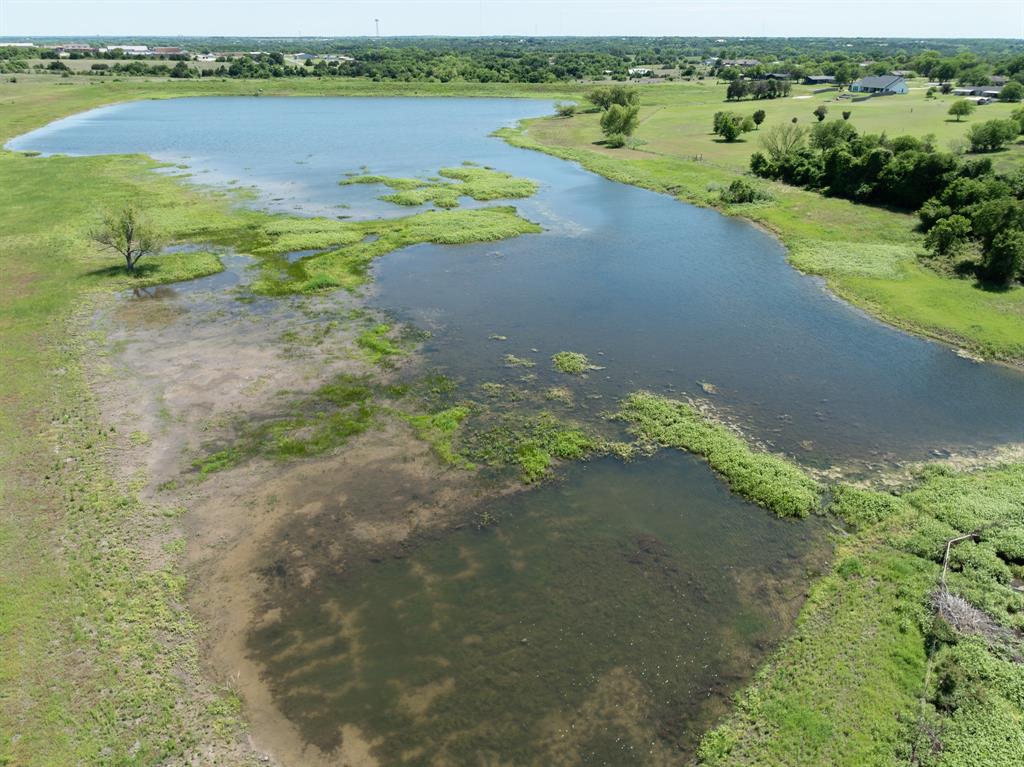 1355 North Houston Street Lorena, TX 76655 - Photo 33 of 40 a view of a lake with houses in the back