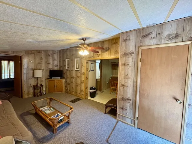 a living room with furniture a flat screen tv and a window