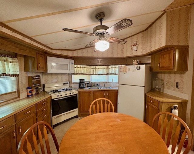 21-244 Woodhaven Sublette, IL 61367 - Photo 16 of 28 a kitchen with stainless steel appliances granite countertop a sink a stove and cabinets