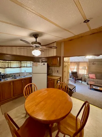 a kitchen with stainless steel appliances wooden cabinets a sink and a stove