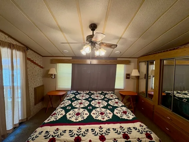 a bedroom with bed and window