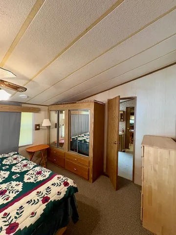 a bedroom with a bed and a tv