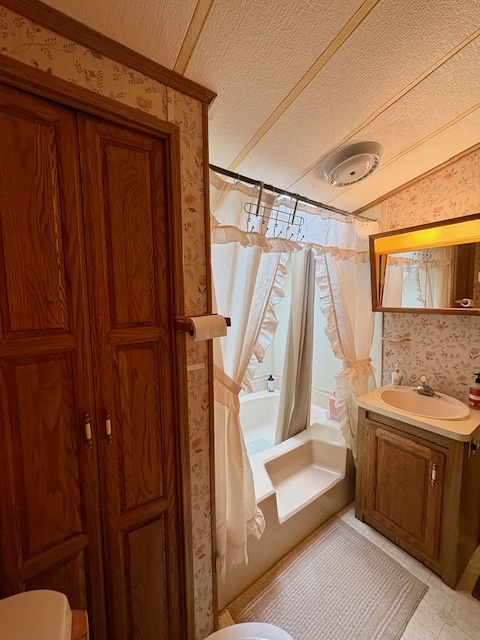 21-244 Woodhaven Sublette, IL 61367 - Photo 27 of 28 a bathroom with a sink a mirror and a shower