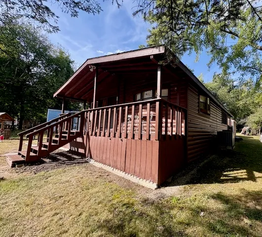 a view of a house with wooden fence