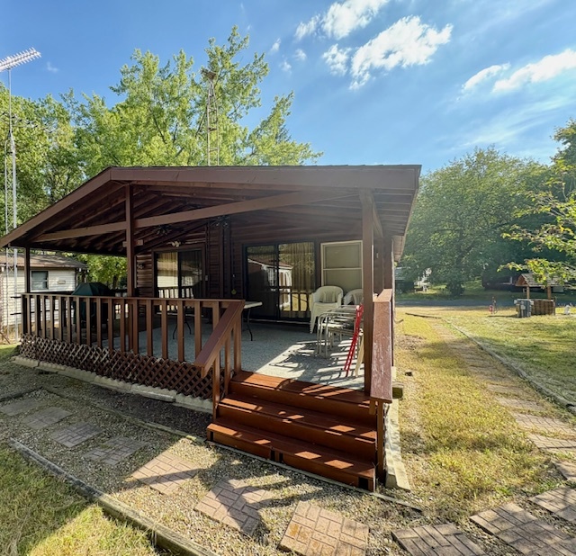 21-244 Woodhaven Sublette, IL 61367 - Photo 5 of 28 a view of a patio with table and chairs with wooden floor and fence