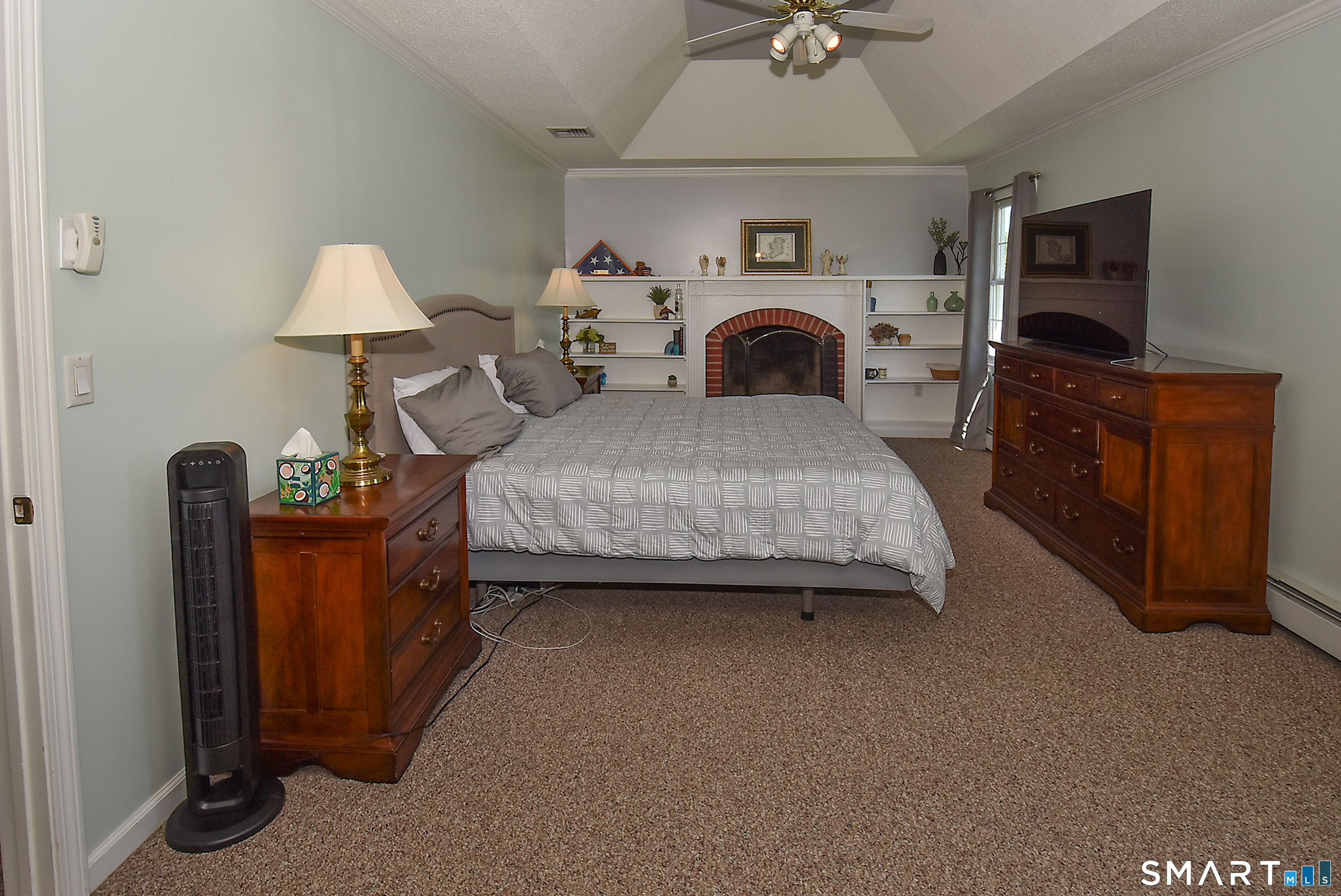 30 Michael Lane Suffield, CT 06078 - Photo 21 of 38 Primary bedroom with tray ceiling, fireplace, built-in shelves, large walk-in closet and en suite bathroom.