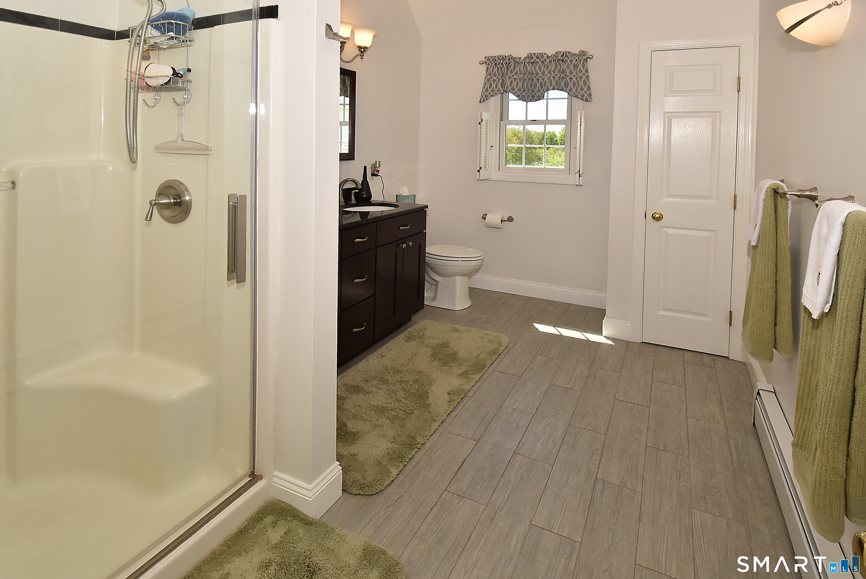 30 Michael Lane Suffield, CT 06078 - Photo 25 of 38 Primary bath with walk in shower, double vanity and cathedral ceilings.