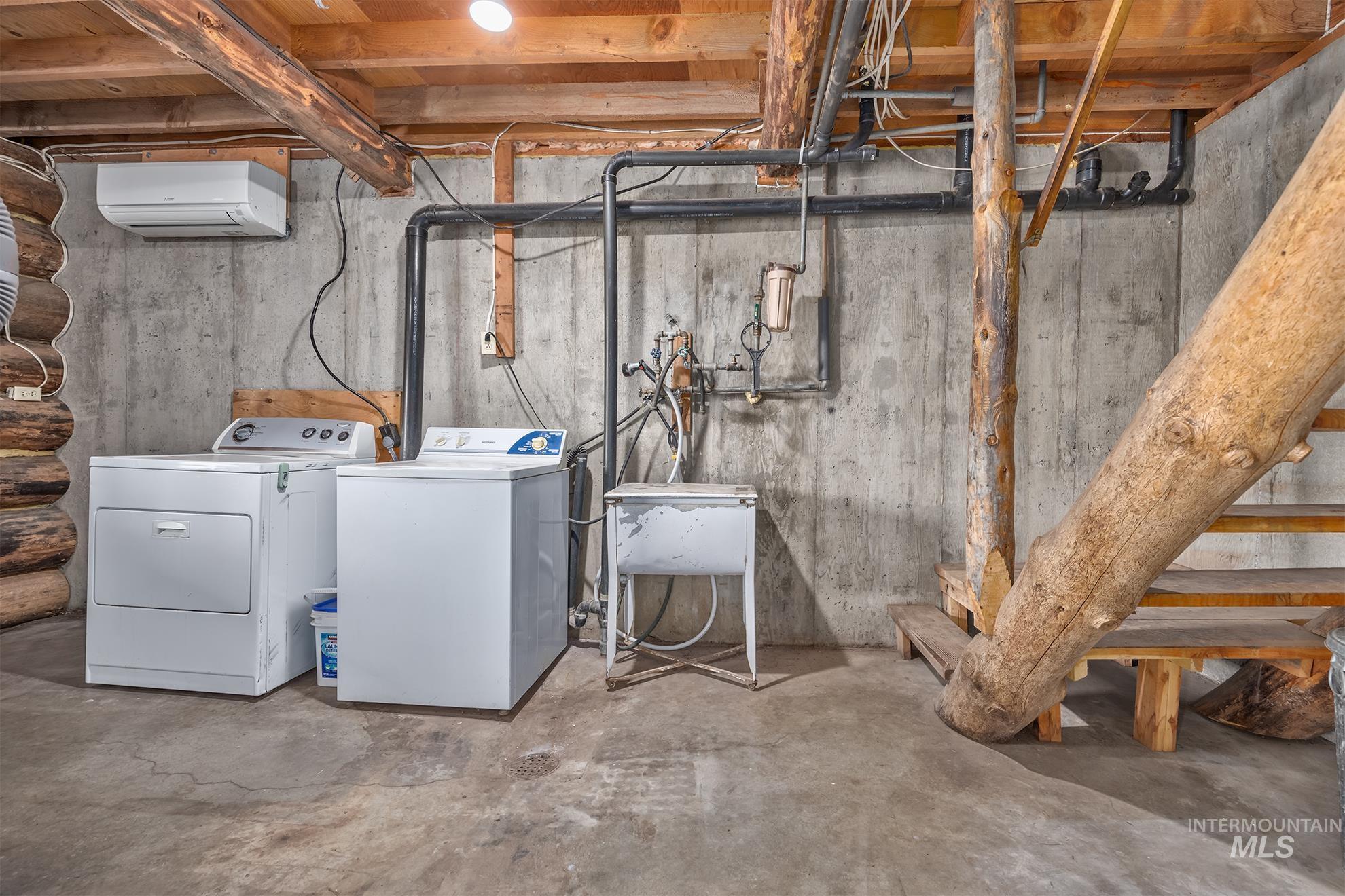 2150 Seid Creek Road Cambridge, ID 83610 - Photo 28 of 50 Utility area featuring a laundry sink, exposed concrete walls, and natural wood support beams