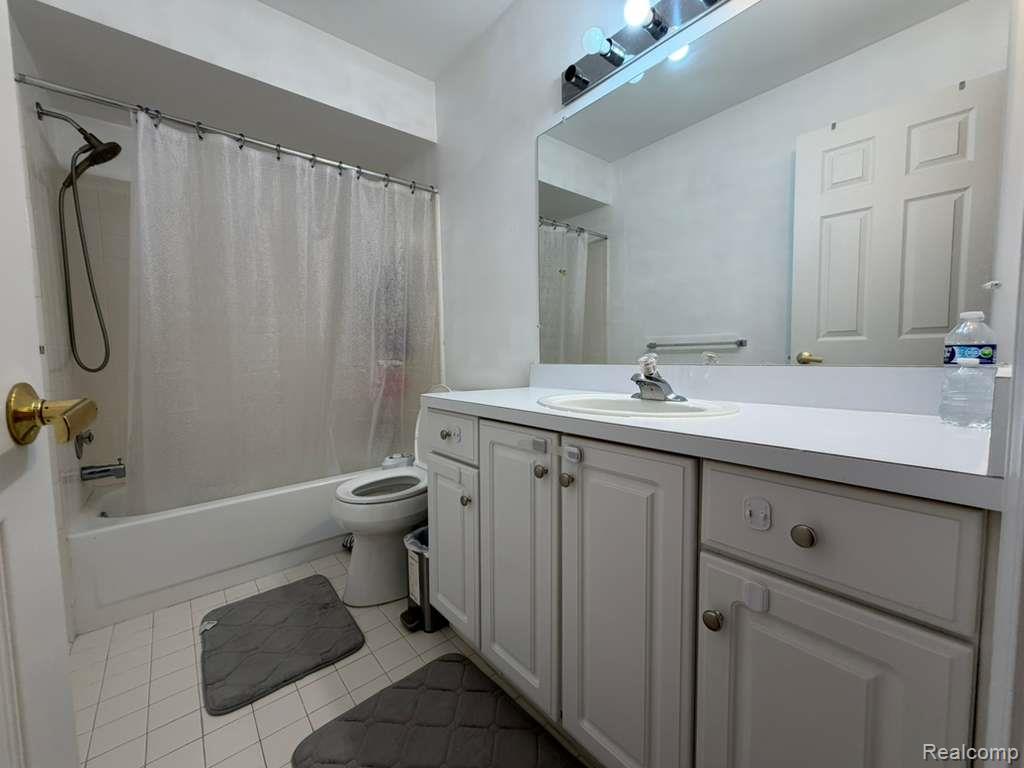1154 Bluebird Drive Rochester, MI 48307 - Photo 17 of 34 Bathroom featuring a vanity with white cabinetry, a single basin sink, and a large wall-mounted mirror