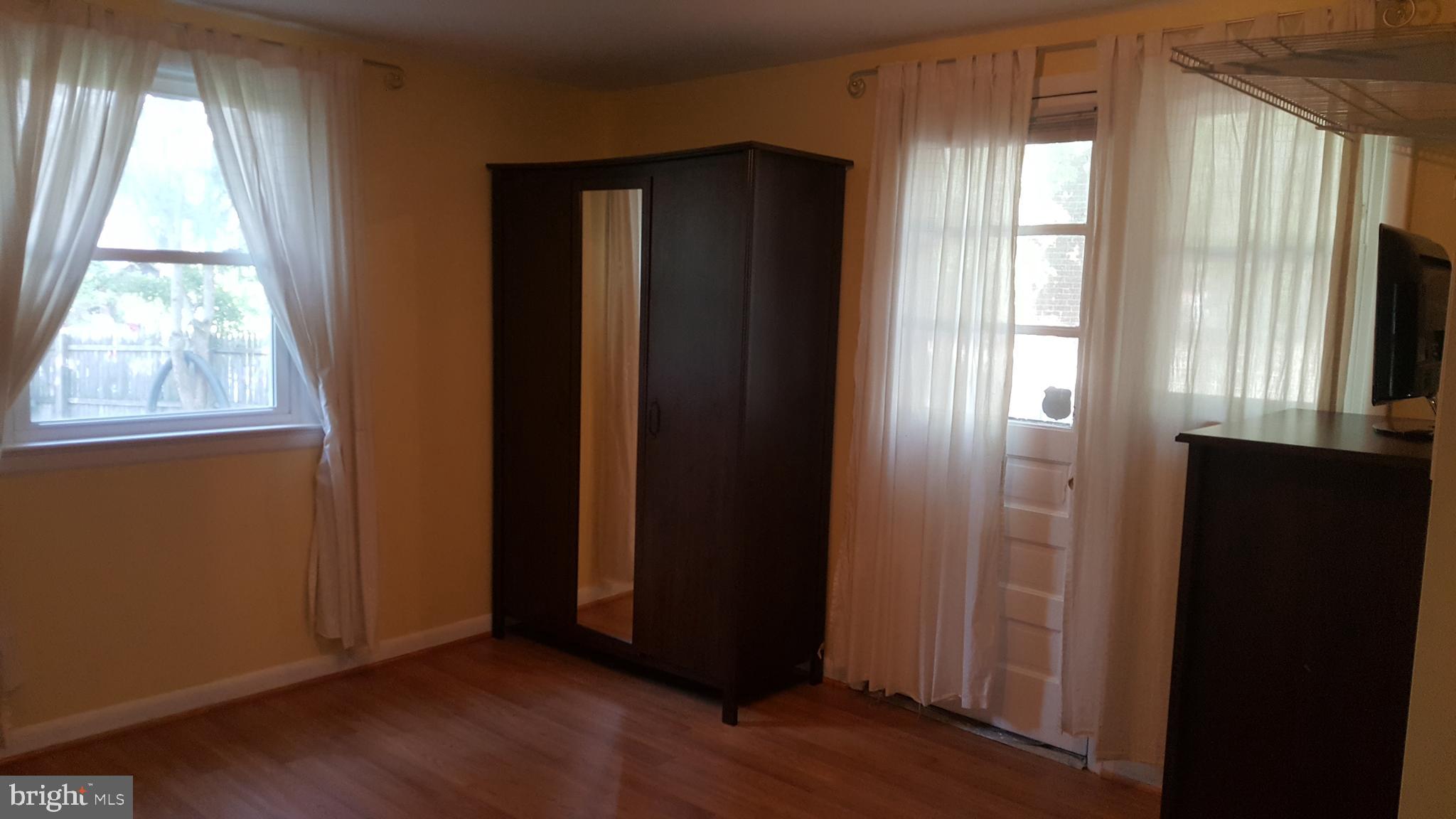 6216 Stoneham Road Bethesda, MD 20817 - Photo 24 of 41 Lower level bedroom - with door leading to patio