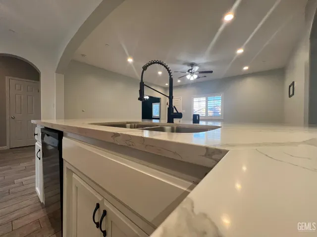 a kitchen with a sink and a mirror