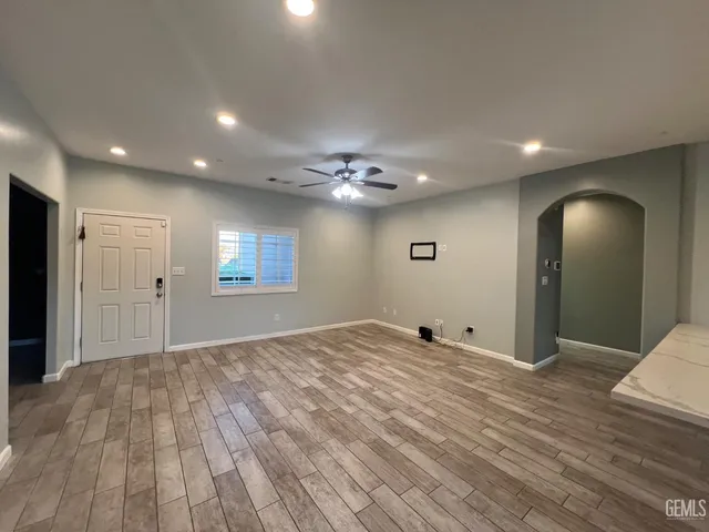 a view of a livingroom with a hall and wooden floor