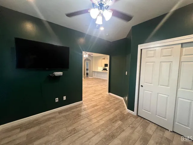 wooden floor in an empty room with a kitchen