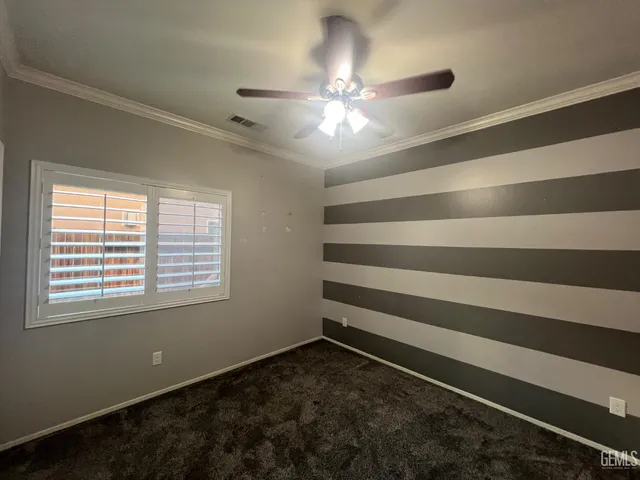 a room with a ceiling fan and a window