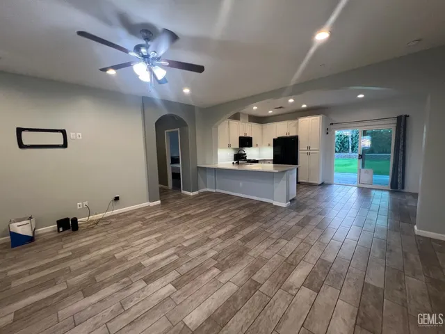 a view of a kitchen with a sink and a large window