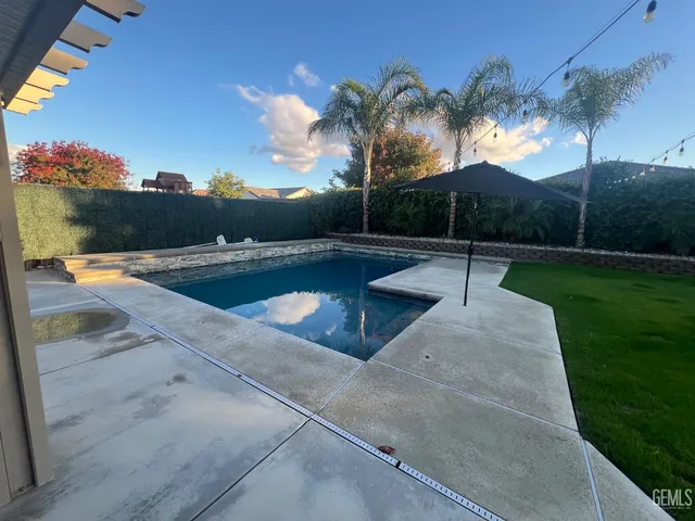 a view of a swimming pool with a patio