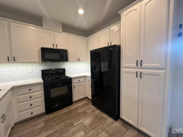 a kitchen with stainless steel appliances and refrigerator