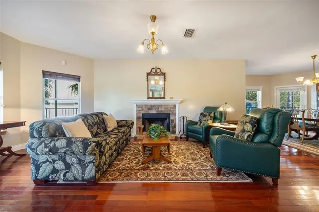a dining table chairs and a chandelier