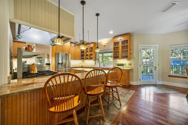 a living room with furniture windows and a potted plant