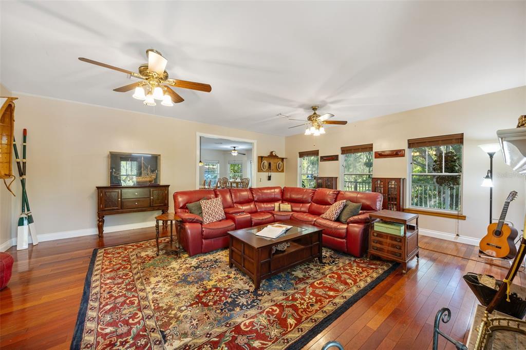 37810 Boyd Road Myakka City, FL 34251 - Photo 29 of 98 a living room with furniture a rug and a chandelier