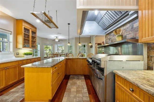 a stove top oven sitting inside of a kitchen
