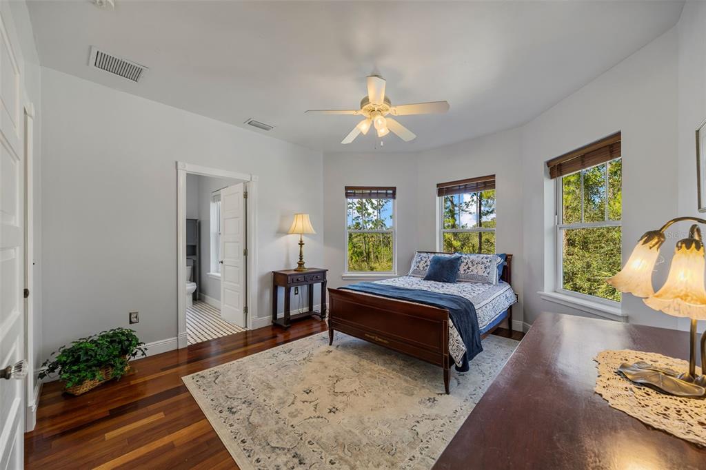 37810 Boyd Road Myakka City, FL 34251 - Photo 45 of 98 a spacious bedroom with a bed and wooden floor