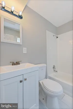 a bathroom with a sink a toilet and vanity