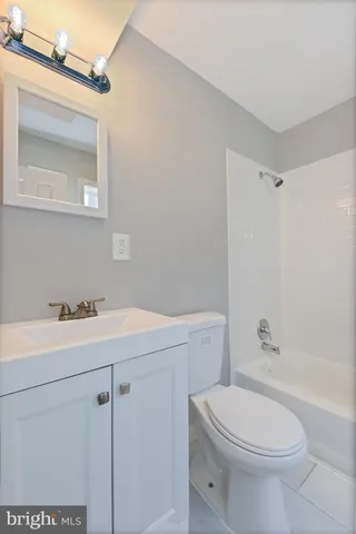 a bathroom with a sink a toilet and vanity