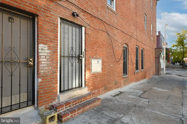 a view of a brick house with many windows