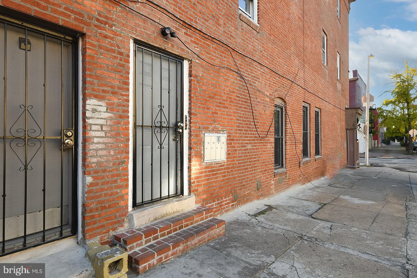 1436 West Baltimore Street, Unit 2 Baltimore, MD 21223 - Photo 10 of 11 a view of a brick house with many windows