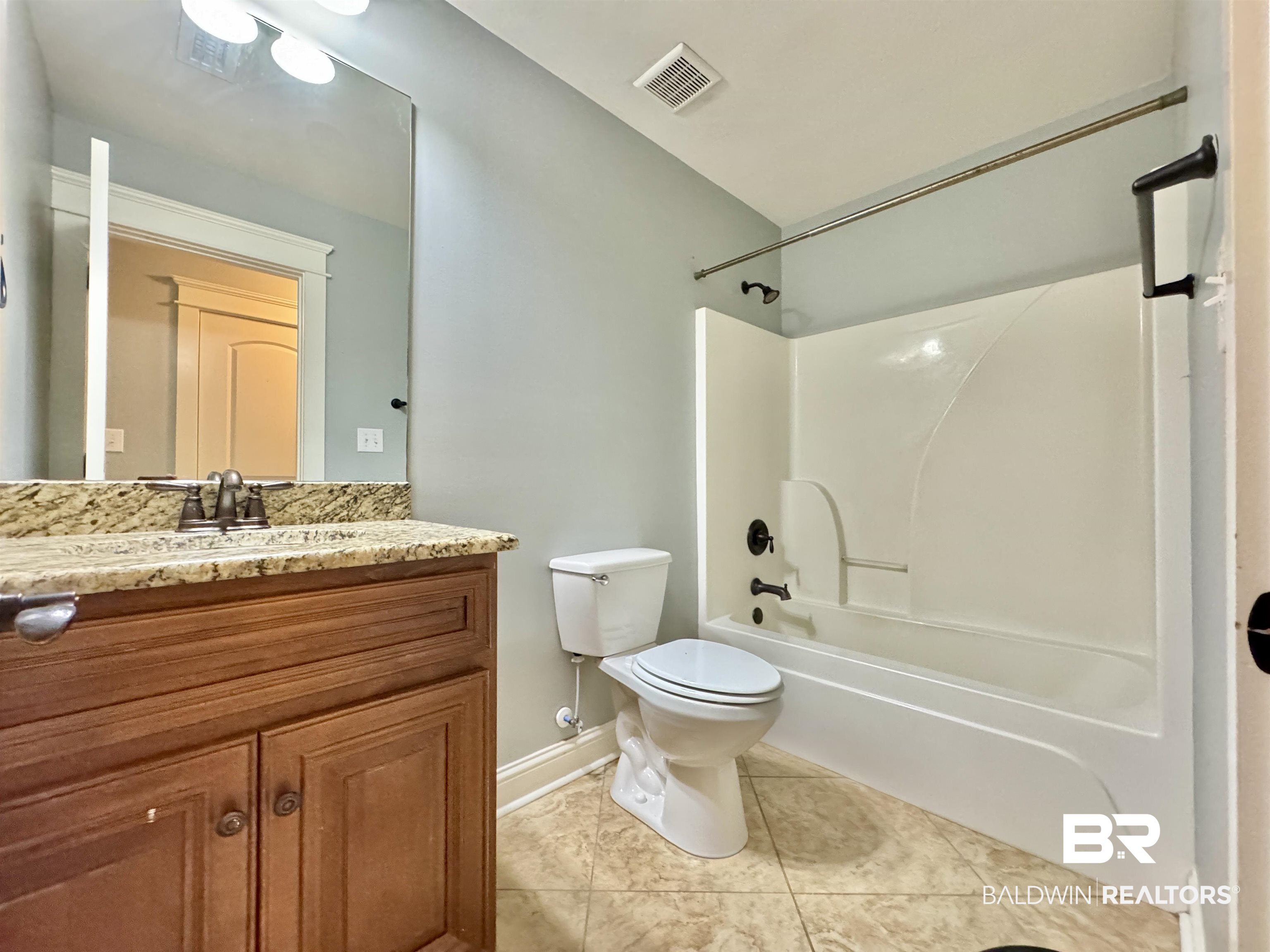 10846 County Road 138 Bay Minette, AL 36507 - Photo 20 of 53 Full bathroom with vanity, tile patterned floors, toilet, and shower / bath combination