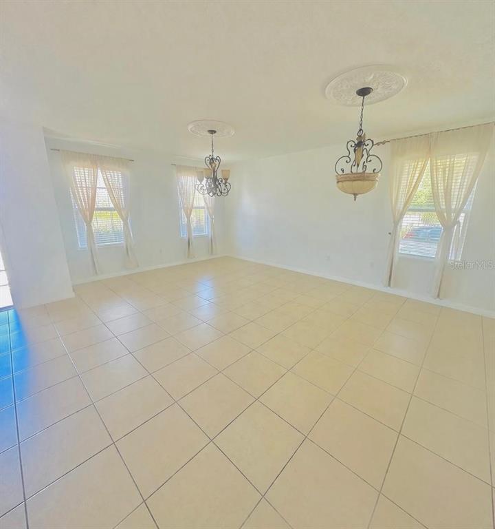 1901 Nations Way St. Cloud, FL 34769 - Photo 15 of 17 an empty room with windows and chandelier