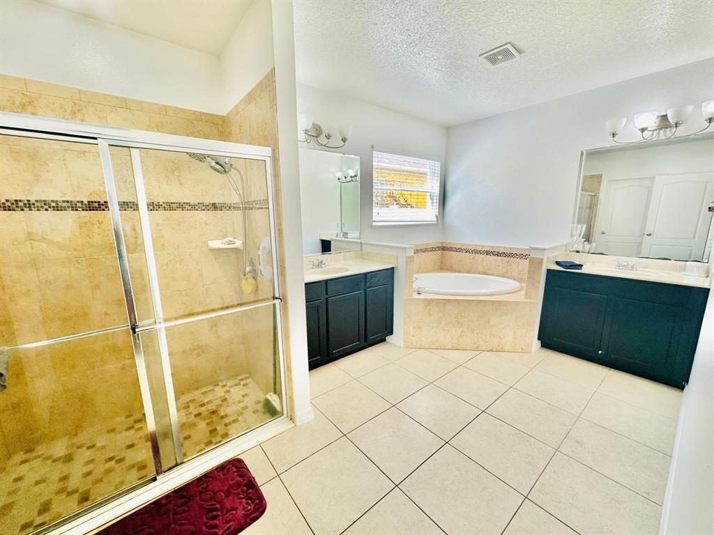 1901 Nations Way St. Cloud, FL 34769 - Photo 6 of 17 a bathroom with a tub sink and mirror