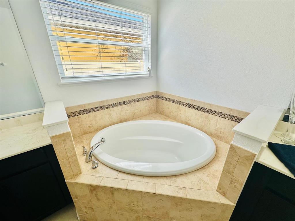 1901 Nations Way St. Cloud, FL 34769 - Photo 8 of 17 a bathroom with a bathtub and a window
