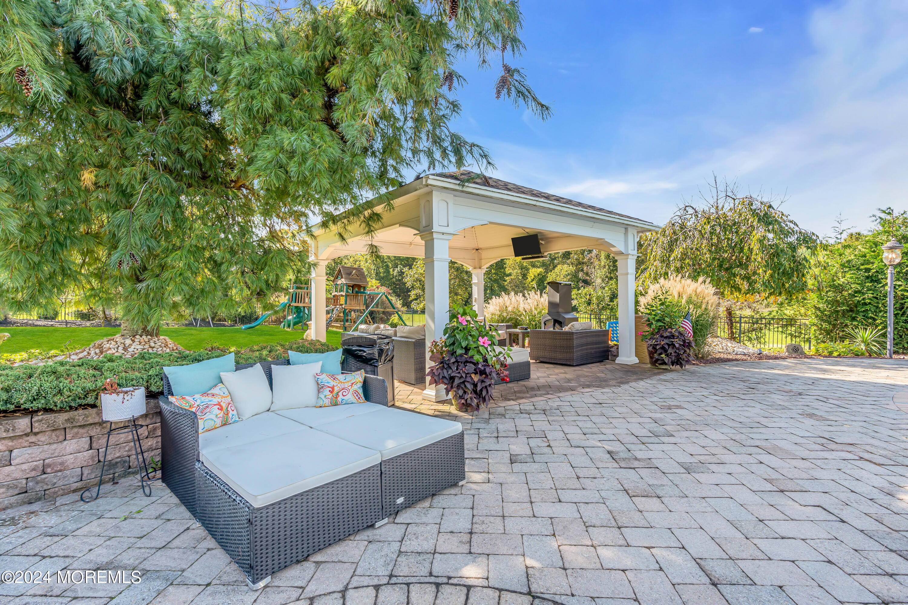 12 Rodeo Drive Jackson, NJ 08527 - Photo 78 of 114 a view of a patio with a table and chairs under an umbrella
