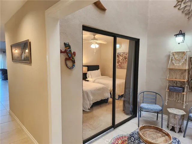 a bedroom with a bed and a lamp on dresser