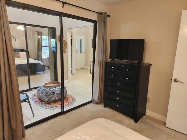 a bedroom with a bed and a television