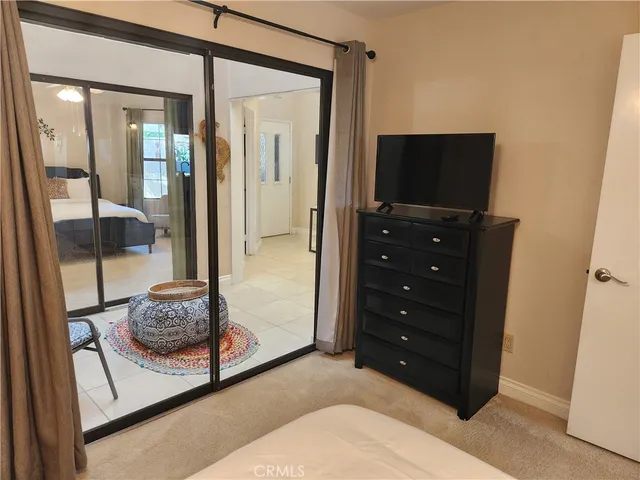 a bedroom with a bed and a television