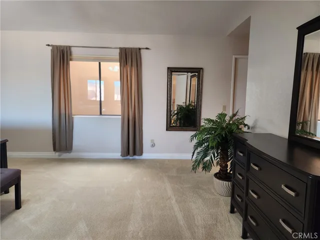 an empty room with windows and cabinet